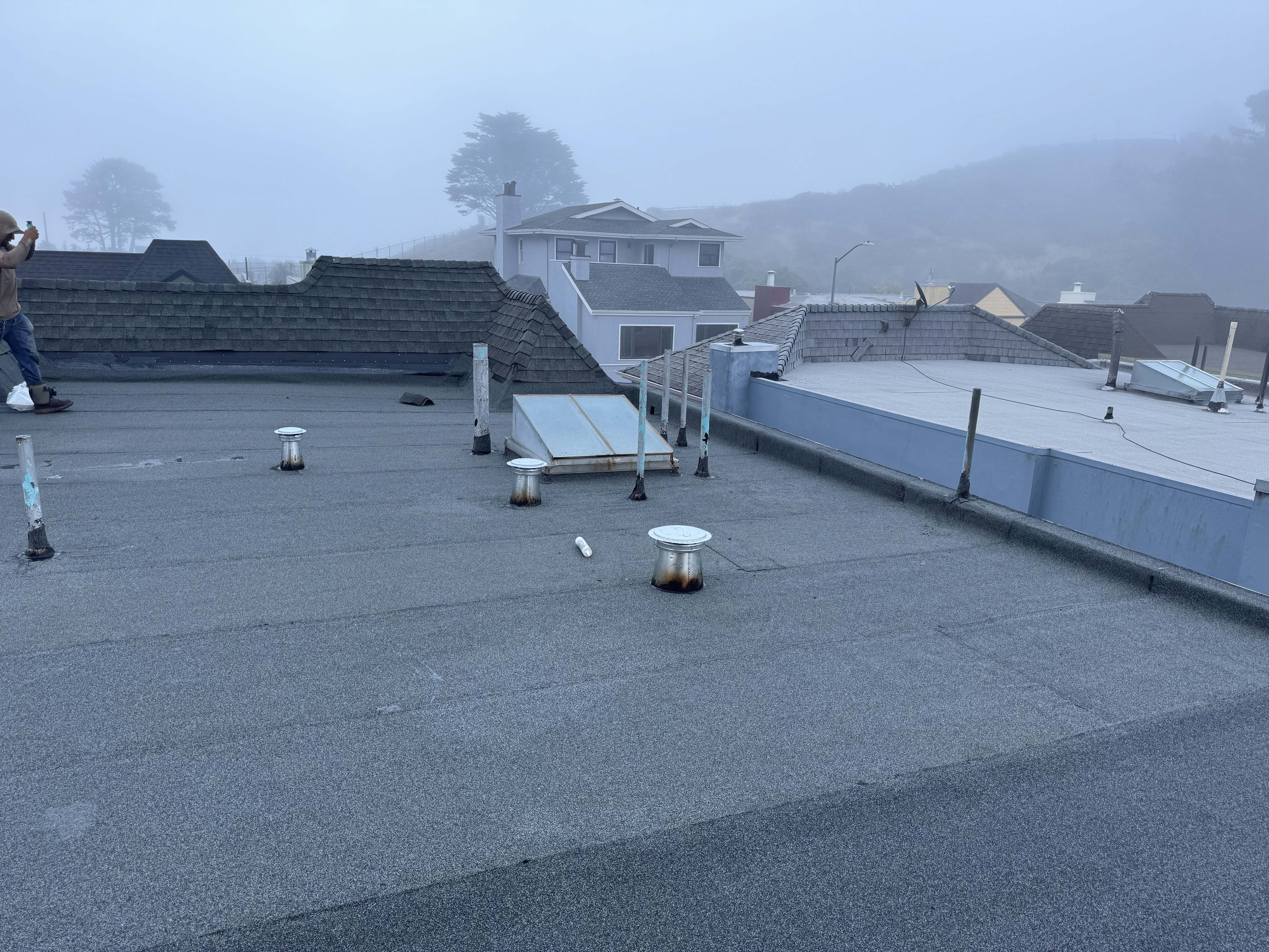Completed residential flat roof replacement in San Francisco, CA showing new TPO membrane and roof vents.